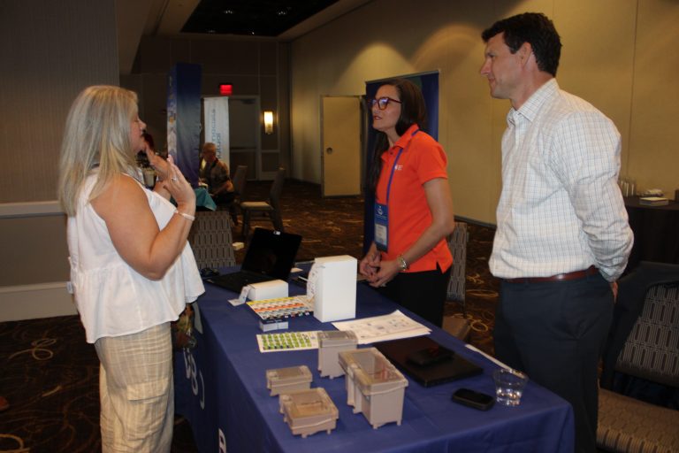 Attendees Visiting Exhibitor Booth