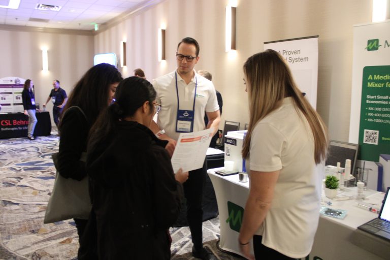 Exhibitor leads discussion with group of attendees